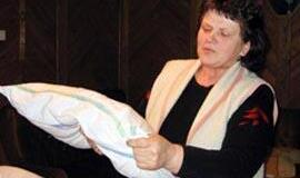 Sveikuolė miega ant pagalvės su vaistažolėmis