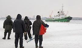 Stintų gaudytojai sėdi laivams ant kelio