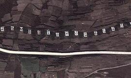 Šiaurės Korėjos lyderis šlovinamas iš kosmoso matomu užrašu