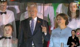 G. Nausėda sveikino Lietuvą po skėčiu, jam už nugaros šlampant berniukams